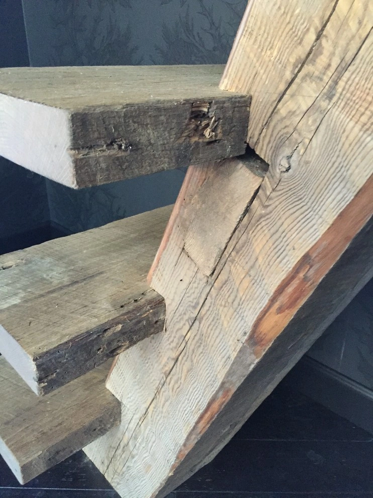 custom-cabinetry-carpentry-5 Close-up of three rustic wooden stair treads attached to a matching wooden staircase support beam.
