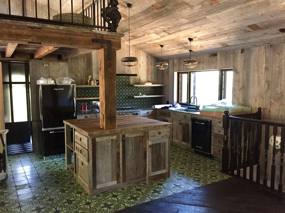 kitchen-remodels-9 Rustic kitchen with wooden cabinets, center island, vintage appliances, and patterned green tile floors.