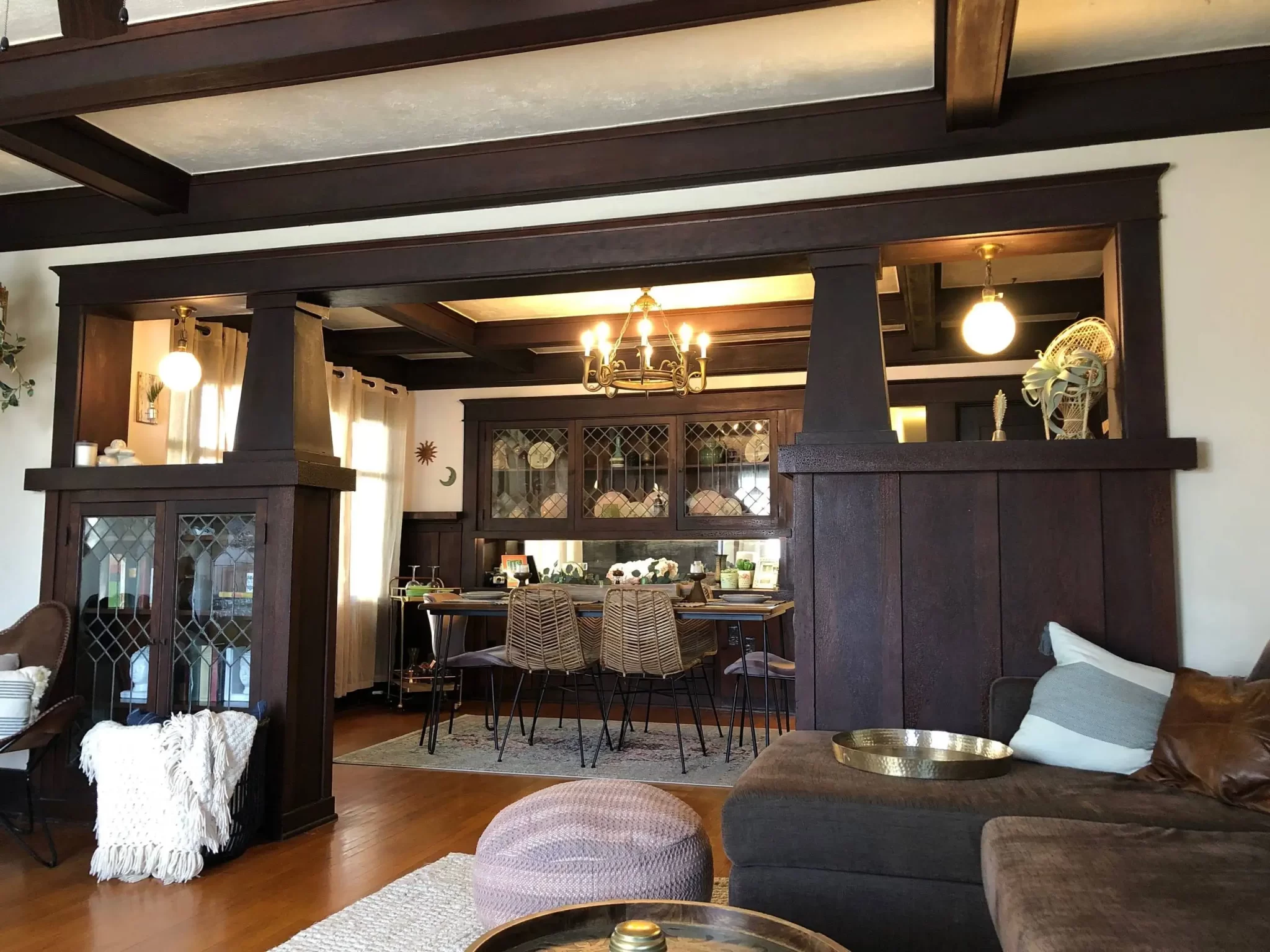 living-spaces-2 Craftsman-style living and dining room with dark wood beams, built-ins, and eclectic decor.